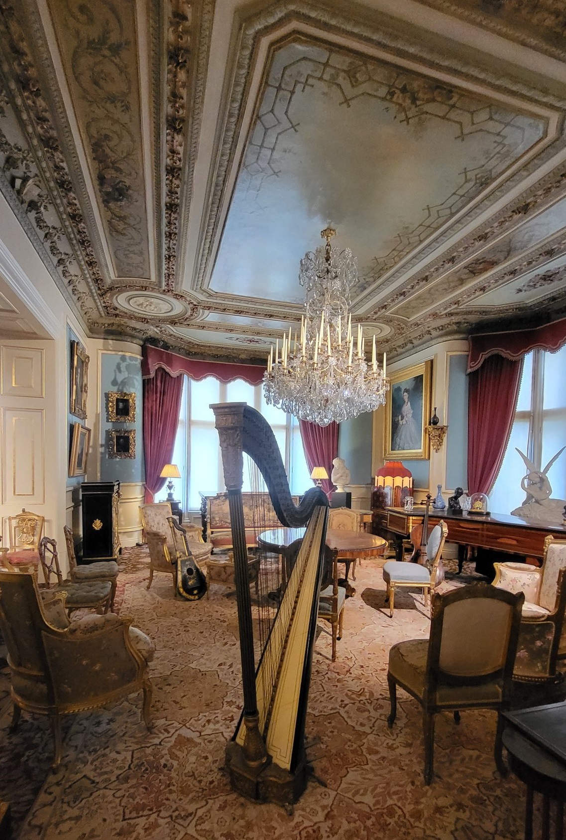 Ornate drawing room with harp in foreground