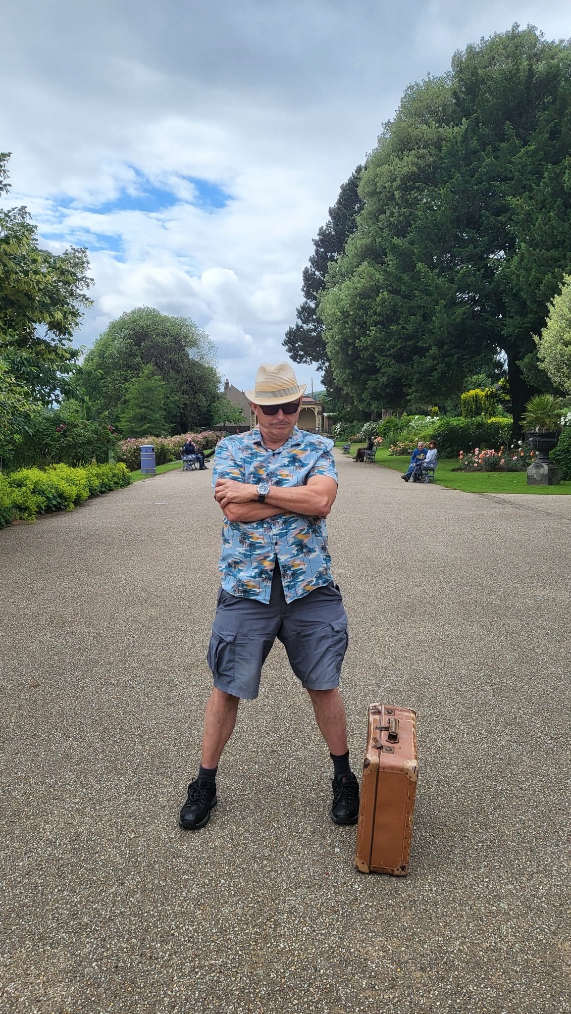 Disgruntled looking spiv in empty park