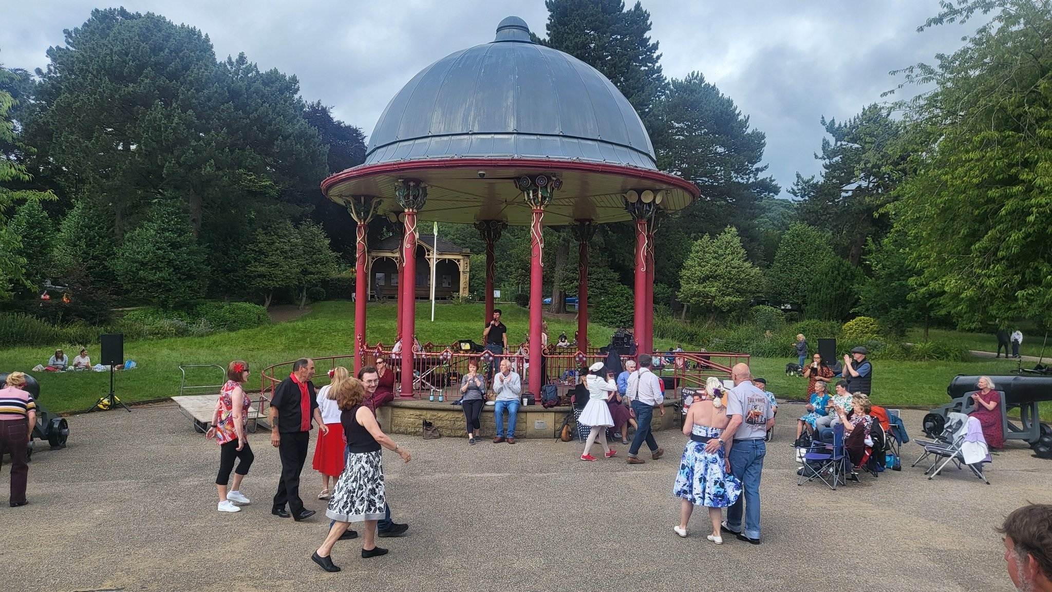 Couples dancing at bandstand in park